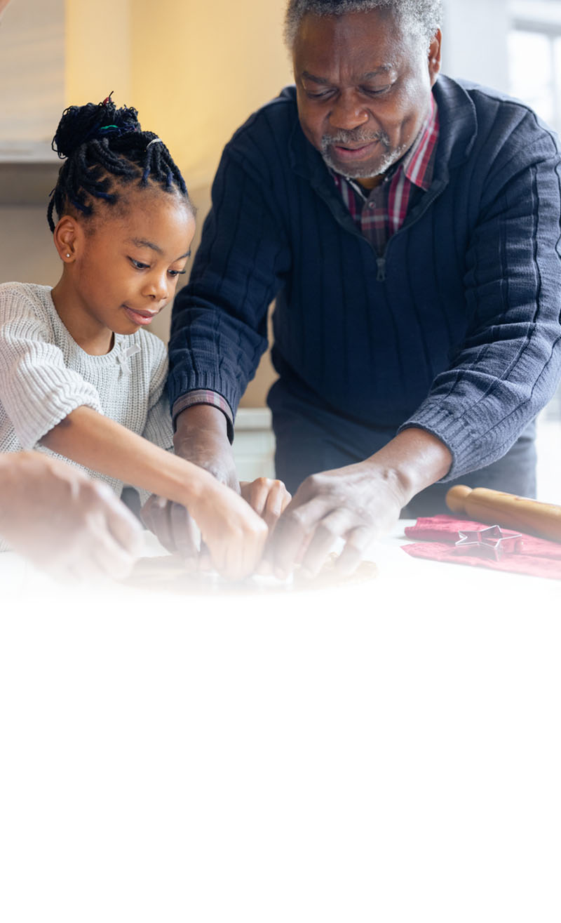 father and daughter making cookies in kitchen